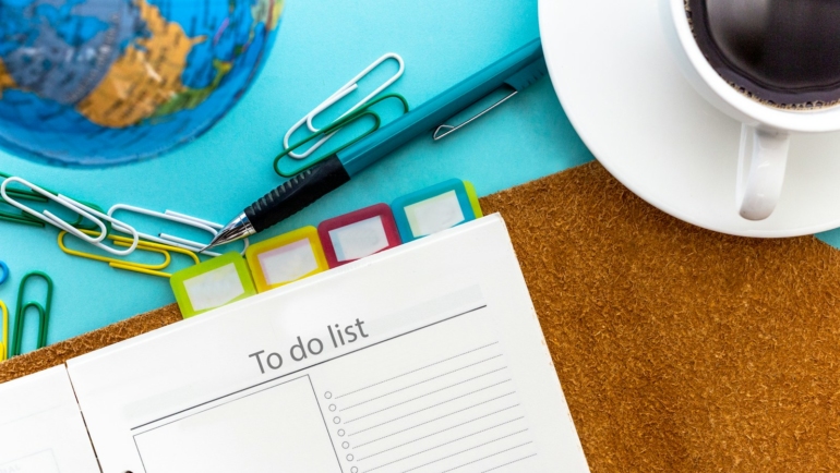 a calendar and scissors on a table